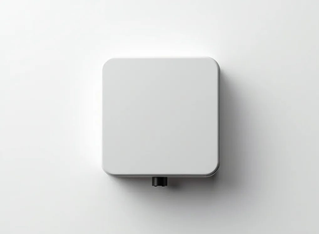 Compact ceramic stone clad EV wallbox charger laid on a pure white surface